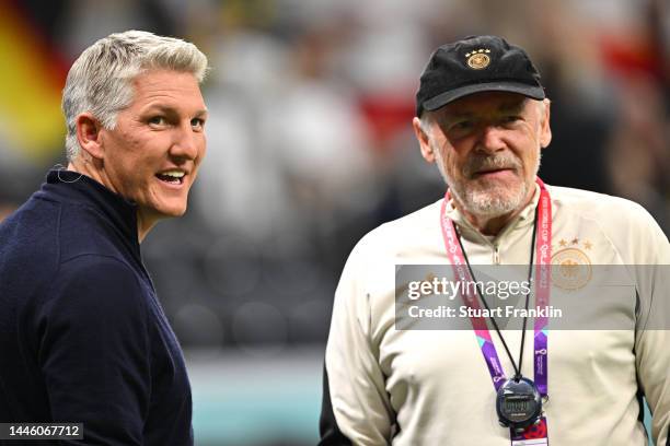 Former player Bastian Schweinsteiger greets assistant coach Hermann Gerland of Germany prior to the FIFA World Cup Qatar 2022 Group E match between...