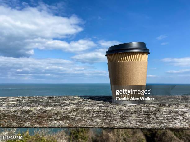 plain disposable paper coffee cup with coastal view - disposal container stock pictures, royalty-free photos & images