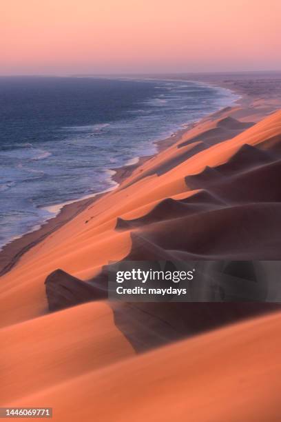 sandwich harbour sand dunes in namibia - walvis bay stock-fotos und bilder