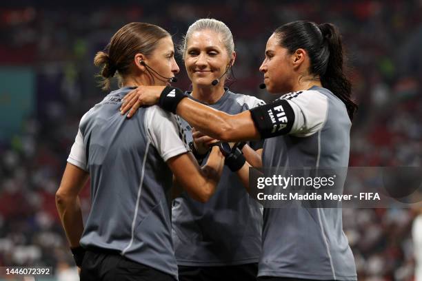 Referees Stephanie Frappart, Neuza Ines Back, and Karen Diaz Medina shake hands as they warm up prior to the FIFA World Cup Qatar 2022 Group E match...