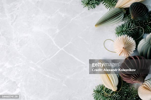 christmas paper decoration honeycomb ornaments and nobilis branch tree. modern festive decor, minimalist and plastic free concept. flat lay, directly above, copy space - yule marble stock pictures, royalty-free photos & images