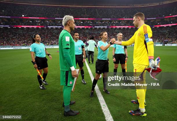 Keylor Navas of Costa Rica and Manuel Neuer of Germany shake hands with referee Stephanie Frappart prior to the FIFA World Cup Qatar 2022 Group E...
