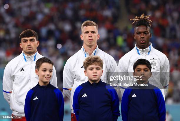 Pedri, Dani Olmo and Nico Williams of Spain line up for the national anthem prior to the FIFA World Cup Qatar 2022 Group E match between Japan and...