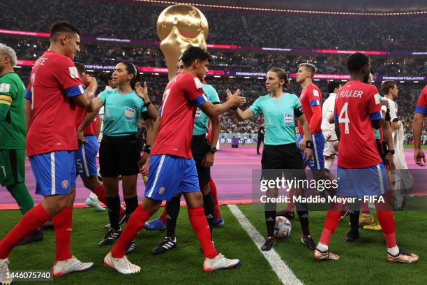 Referees Karen Diaz Medina, Stephanie Frappart and Neuza Ines Back shake hands with players prior to the FIFA World Cup Qatar 2022 Group E match...