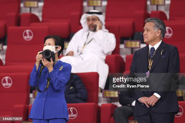 Japan's Princess Hisako of Takamado takes photographs while Japan Football Association President Kozo Tashima watches prior to the FIFA World Cup...