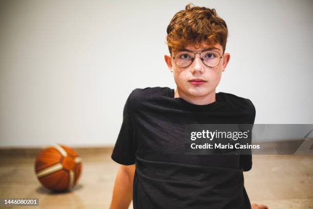 portrait of teenage boy with basketball ball - boys sport pants stock pictures, royalty-free photos & images