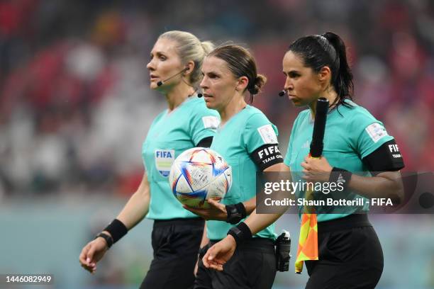 Referees Neuza Ines Back, Stephanie Frappart and Karen Diaz Medina walk off the pitch after the first half during the FIFA World Cup Qatar 2022 Group...