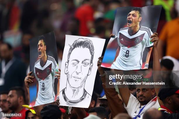 Fans hold banners of former Germany player Mesut Oezil during the FIFA World Cup Qatar 2022 Group E match between Costa Rica and Germany at Al Bayt...