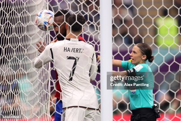 Referee Stephanie Frappart speaks with Kai Havertz of Germany after they scored Germany's second goal during the FIFA World Cup Qatar 2022 Group E...