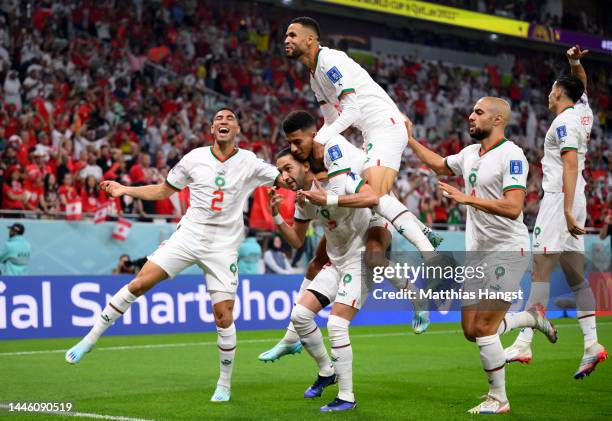 Hakim Ziyech of Morocco celebrates with teammates after scoring the team's first goal during the FIFA World Cup Qatar 2022 Group F match between...