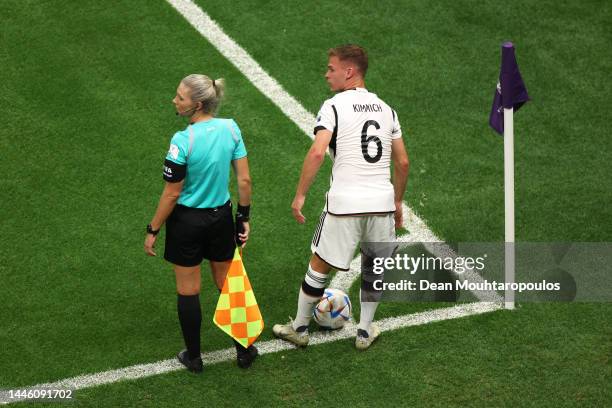 Joshua Kimmich of Germany prepares to take a corner kick as assistant referee Neuza Ines Back looks on during the FIFA World Cup Qatar 2022 Group E...