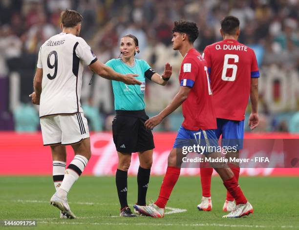 Referee Stephanie Frappart speaks with Niclas Fuellkrug of Germany before awarding Germany their fourth goal after a VAR check during the FIFA World...