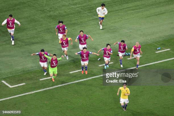 Japan players celebrate their 2-1 victory and qualification for the knockout stage after the FIFA World Cup Qatar 2022 Group E match between Japan...