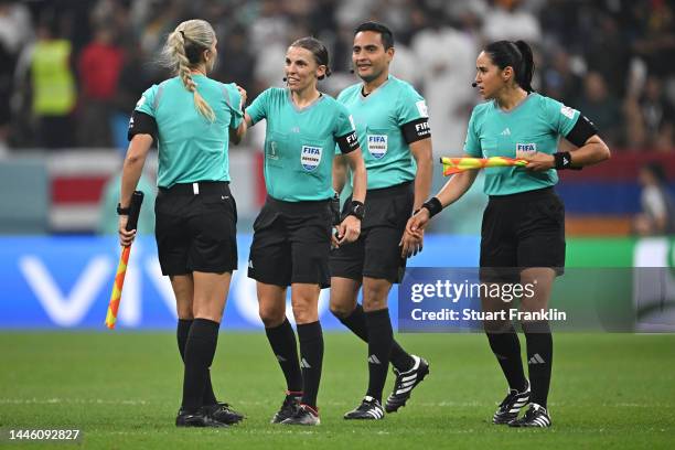 Referee Stephanie Frappart embraces assistants Neuza Back and Karen Diaz Medina after the FIFA World Cup Qatar 2022 Group E match between Costa Rica...