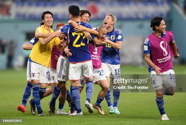 Maya Yoshida and Japan players celebrate their 2-1 victory and qualification for the knockout stage after the FIFA World Cup Qatar 2022 Group E match...