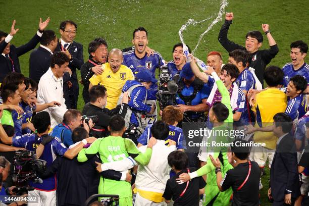 Japan players and staffs celebrate their 2-1 victory and qualification for the knockout stage after the FIFA World Cup Qatar 2022 Group E match...