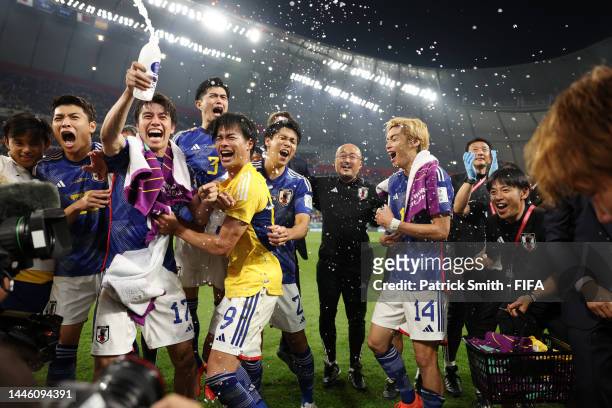 Japan players celebrate their 2-1 victory and qualification for the knockout stage after the FIFA World Cup Qatar 2022 Group E match between Japan...