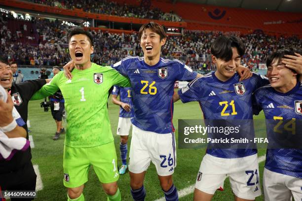 Shuichi Gonda, Hiroki Ito, Ayase Ueda and Yuki Soma of Japan celebrate their 2-1 victory and qualification for the knockout stage after during the...