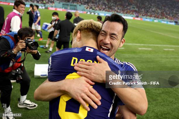 Ritsu Doan and Maya Yoshida of Japan celebrate their 2-1 victory and qualification for the knockout stage after the FIFA World Cup Qatar 2022 Group E...