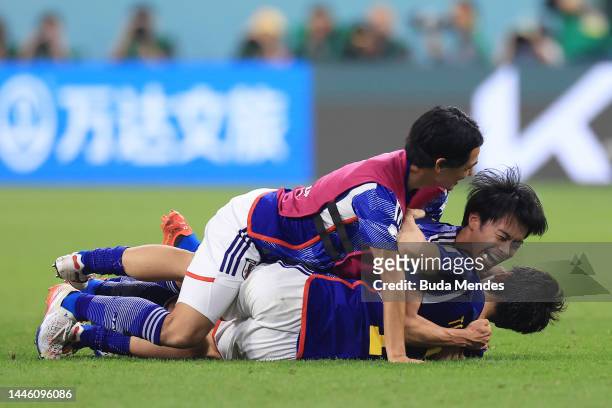 Japan players celebrate after the team's qualification to the knockout stages during the FIFA World Cup Qatar 2022 Group E match between Japan and...