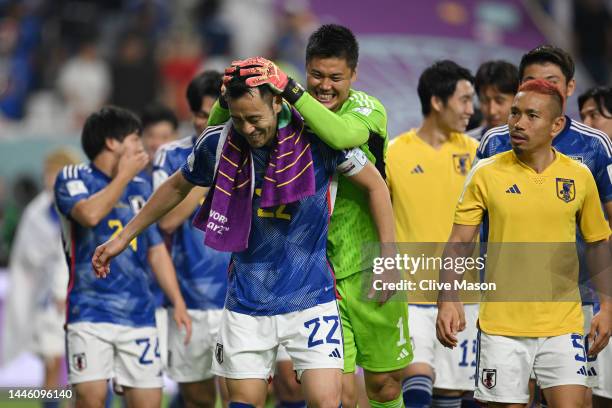 Maya Yoshida of Japan is congratulated by Eiji Kawashima after their 2-1 victory and qualification for the knockout stage after the FIFA World Cup...