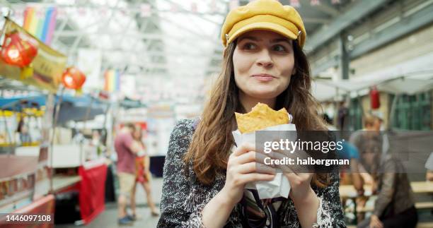 frau beim essen street food in greenwich market - women pastel stock-fotos und bilder