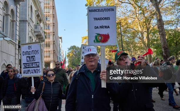Members of "Habeas Corpus" and "2126" associations hold signs while parading in protest for human rights through Avenida da Liberdade, on occasion of...