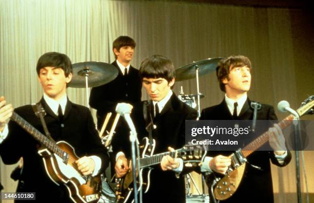 The Beatles performing on stage, circa 1963. Left to right: Paul McCartney, Ringo Starr, George Harrison and John Lennon .