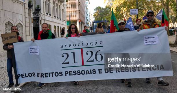 Members of "Habeas Corpus" and "2126" associations walk behind a banner while parading in protest for human rights through Avenida da Liberdade, on...