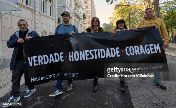 Members of "Habeas Corpus" and "2126" associations carry a banner while parading in protest for human rights through Avenida da Liberdade, on...