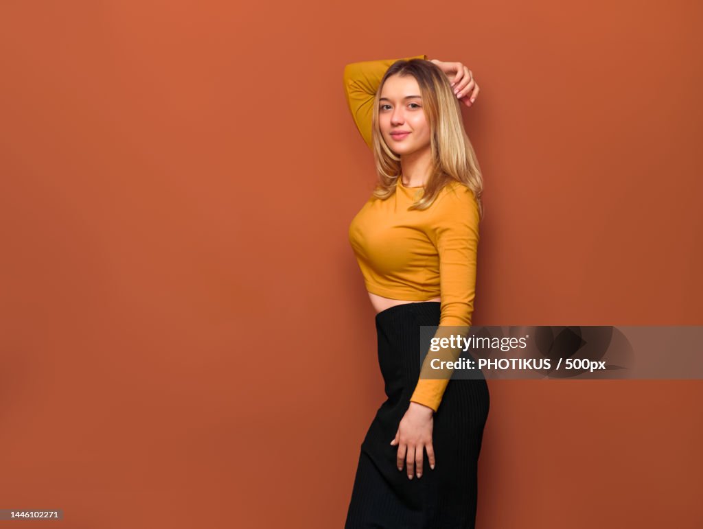 Side view of beautiful young blonde girl with big breasts,With her hand behind head,Ukraine