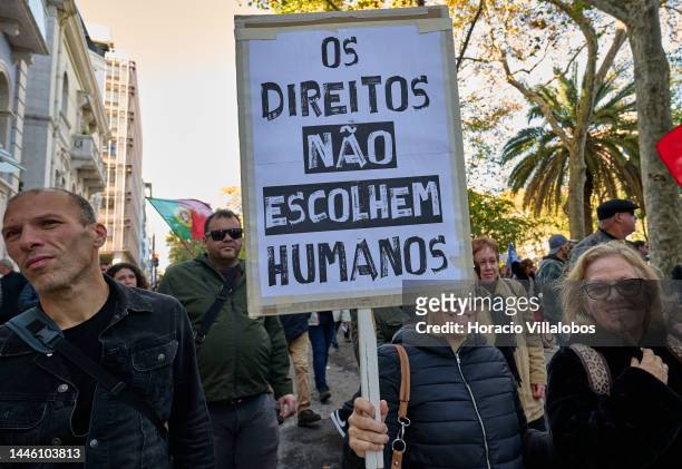 Members of "Habeas Corpus" and "2126" associations hoist a sign while parading in protest for human rights through Avenida da Liberdade, on occasion...