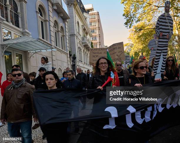 Members of "Habeas Corpus" and "2126" associations hoist signs while parading in protest for human rights through Avenida da Liberdade, on occasion...