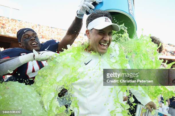 Head coach Jedd Fisch of the Arizona Wildcats is dunked with powerade after defeating the Arizona State Sun Devils 38-35 in the NCAAF game at Arizona...