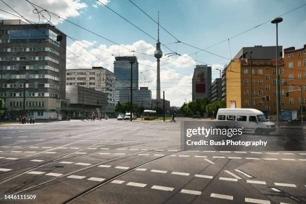 road markings on road intersection in berlin with the tv tower in the background. berlin, germany - traffic crossing stock pictures, royalty-free photos & images