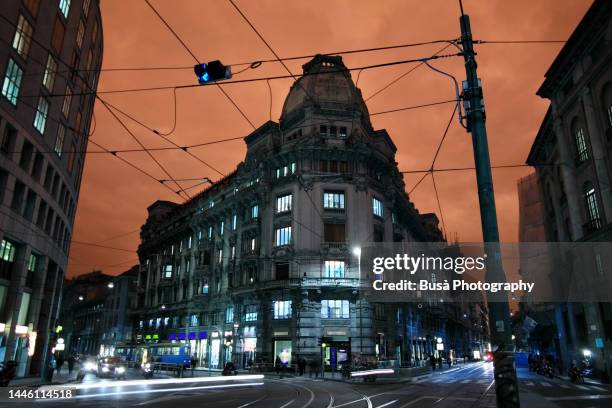 manipulated image / ornate art nouveau office building at road intersection in the center of milan, italy - false colored stock pictures, royalty-free photos & images