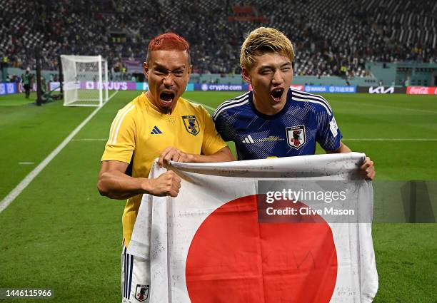 Ritsu Doan and Yuto Nagatomo of Japan pose for photographers after their 2-1 victory and qualification for the knockout stage following during the...
