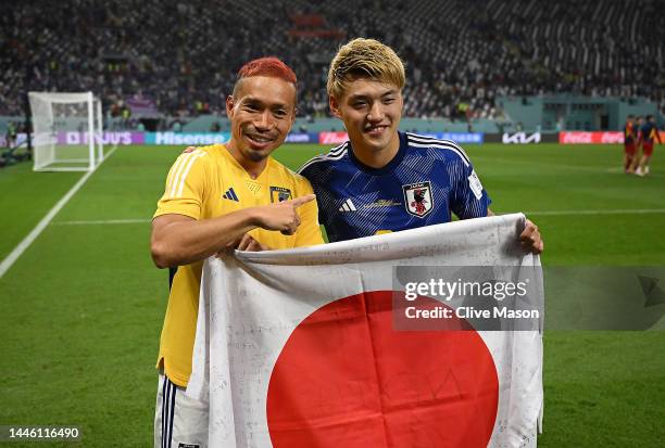 Ritsu Doan and Yuto Nagatomo of Japan pose for photographers after their 2-1 victory and qualification for the knockout stage following during the...