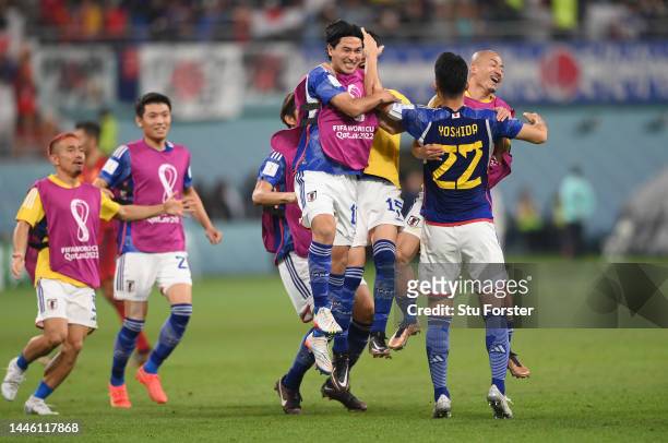 Japan players celebrate with captain Maya Yoshida after the FIFA World Cup Qatar 2022 Group E match between Japan and Spain at Khalifa International...