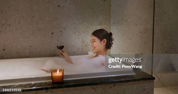 woman take a bath - woman bath bubbles stock pictures, royalty-free photos & images