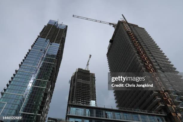 looking up three tall buildings under construction - vmc stock pictures, royalty-free photos & images