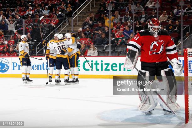 The Nashville Predators celebrate a first period goal by Colton Sissons against Vitek Vanecek of the New Jersey Devils at the Prudential Center on...