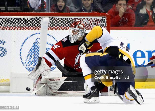 Ryan Johansen of the Nashville Predators scores at 33 seconds of overtime to defeat Vitek Vanecek and the New Jersey Devils 4-3 at the Prudential...