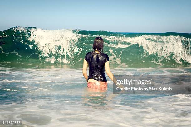 woman on beaches of great barrier island - waist deep in water stock pictures, royalty-free photos & images