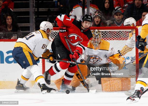 Yegor Sharangovich of the New Jersey Devils controls the puck in front of Juuse Saros of the Nashville Predators during the third period at the...