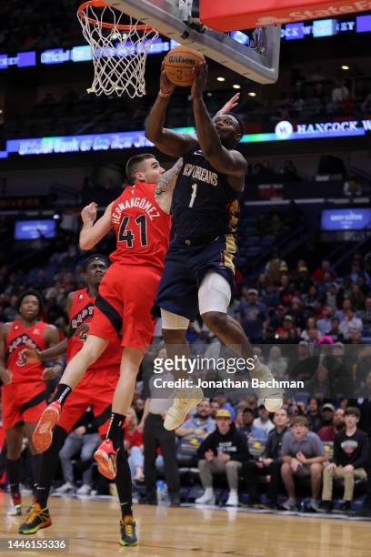 Zion Williamson of the New Orleans Pelicans shoots against Juancho Hernangomez of the Toronto Raptors during a game at the Smoothie King Center on...