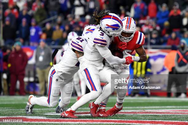 Safety Damar Hamlin and safety Jordan Poyer of the Buffalo Bills break up a pass intended for wide receiver Jakobi Meyers of the New England Patriots...