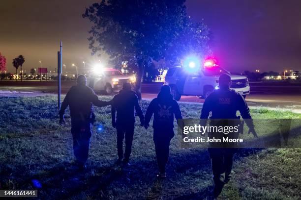 Border Patrol agents detain a group of immigrants near the U.S.-Mexico border on December 01, 2022 in McAllen, Texas. The group had crossed the Rio...