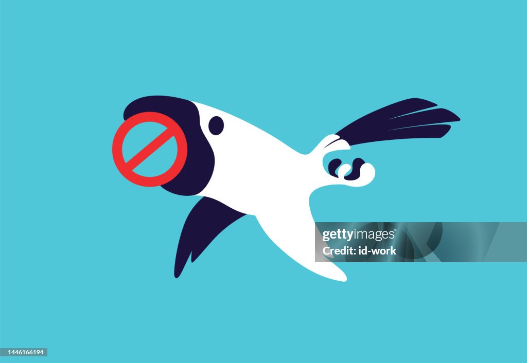 Parrot flying and holding prohibition sign