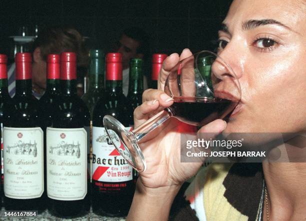 Lebanese woman tastes a glass of wine, 28 September in Beirut. Lebanese producers are planting quality vines and hiring French oenophiles to enhance...